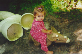 Ilana riding a triceratops